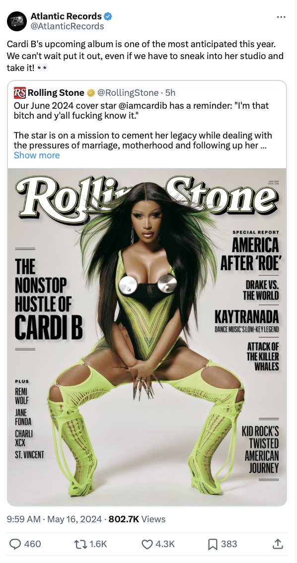 Cardi B poses in a striking outfit with a feathered headpiece and knee-high boots for Rolling Stone cover
