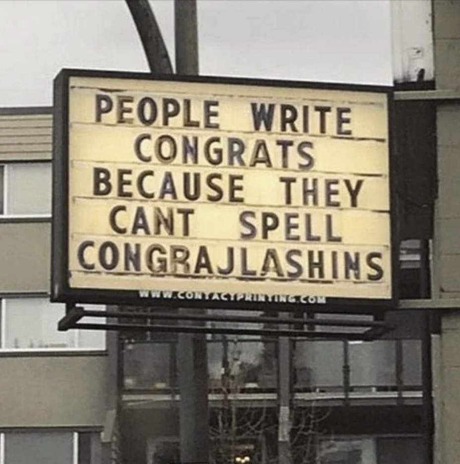 Signboard with humorous message about misspelling &#x27;congratulations&#x27; as &#x27;congrajlashins&#x27;