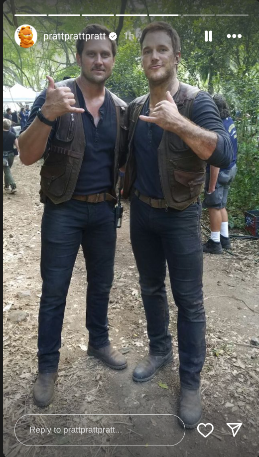 Chris Pratt and a stunt double pose together on set, giving a thumbs-up, both in costume