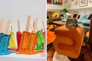 A cat sits atop a a velvet s-shaped ottoman; "melting" resin ice pops