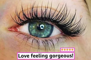 Close-up of an eye with dramatic long false eyelashes and text, "Love feeling gorgeous!" with five pink stars below