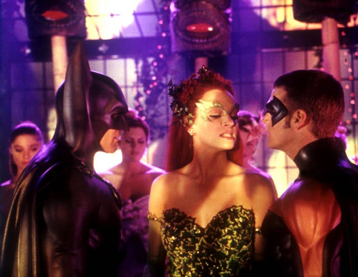 Batman, Poison Ivy, and Robin in costume at a gala event from a Batman film