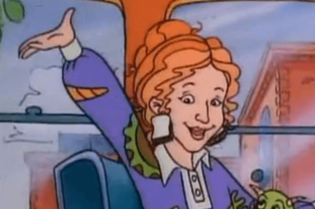 Animated character Ms. Frizzle with a lizard, gesturing excitedly on the Magic School Bus