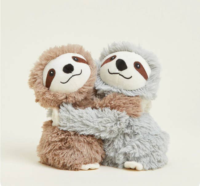 Two plush sloth toys hugging, 1 brown, 1 gray