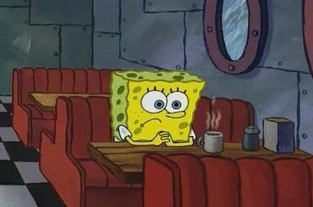 SpongeBob SquarePants sits alone in a diner booth, looking contemplative, with a cup of hot beverage in front of him