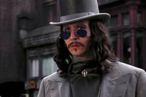 Gary Oldman as Count Dracula in the movie 'Bram Stoker's Dracula,' wearing a top hat, sunglasses, and an elegant suit