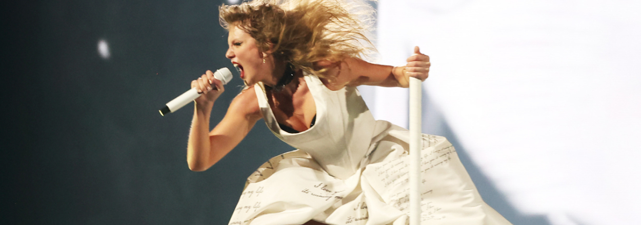 Taylor Swift singing on stage enthusiastically