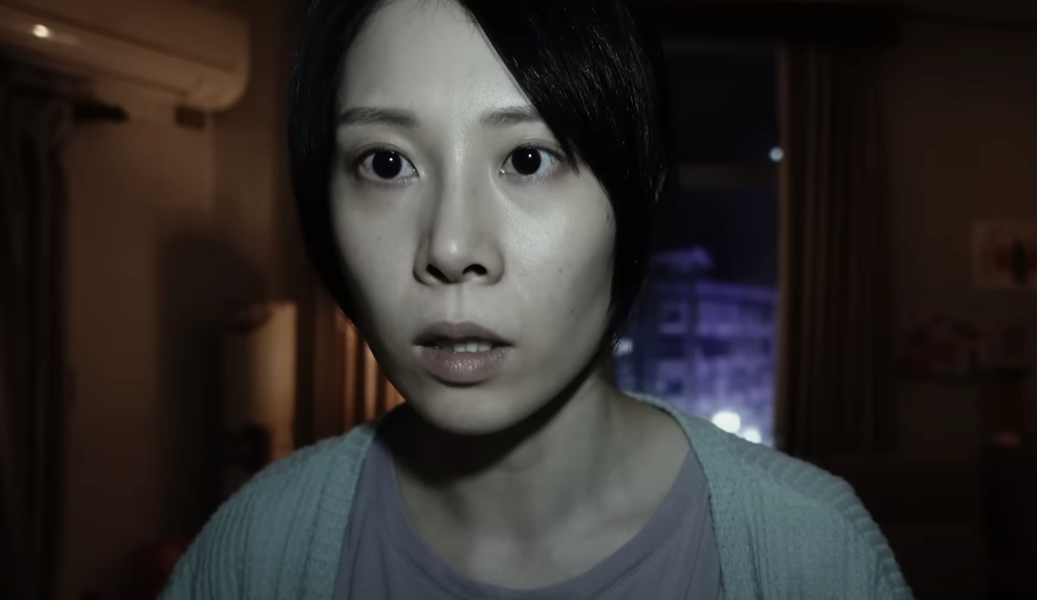 Close-up of a woman with an expression of shock or fear