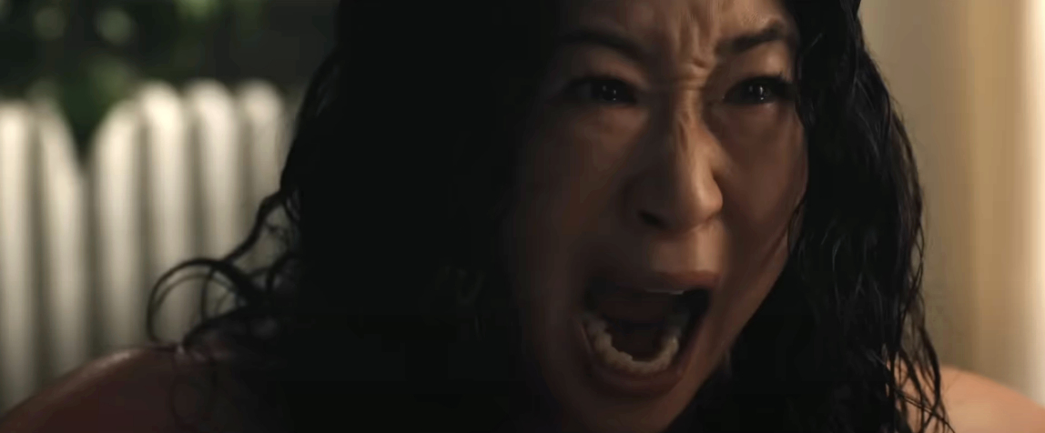 Sandra Oh, portraying a distressed character, is screaming with an intense expression