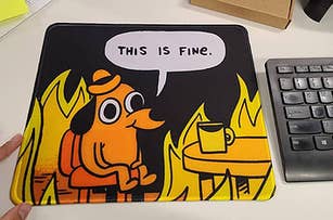 a "this is fine" dog meme mouse pad