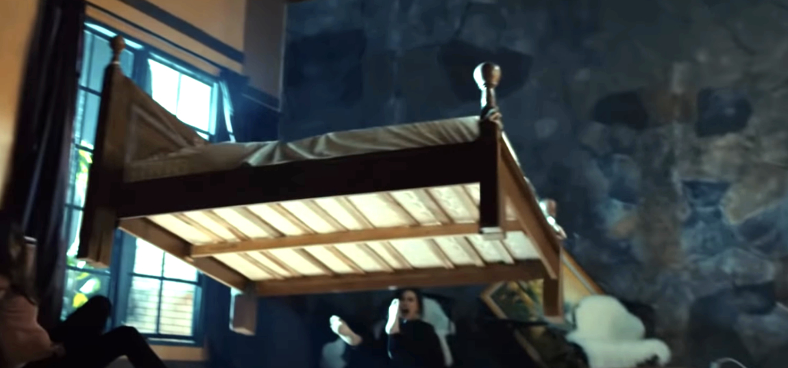 A bed floats in mid-air