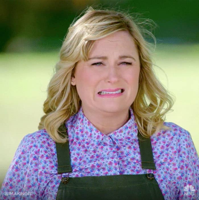 A woman cringing