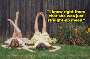 Two people lying on their backs with legs against a wooden fence, flowers nearby. Text reads, "I knew right there that she was just straight-up mean."