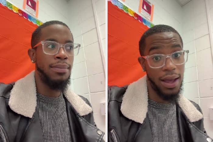 Man with glasses in a jacket with a fur collar indoors, with art on the wall behind him