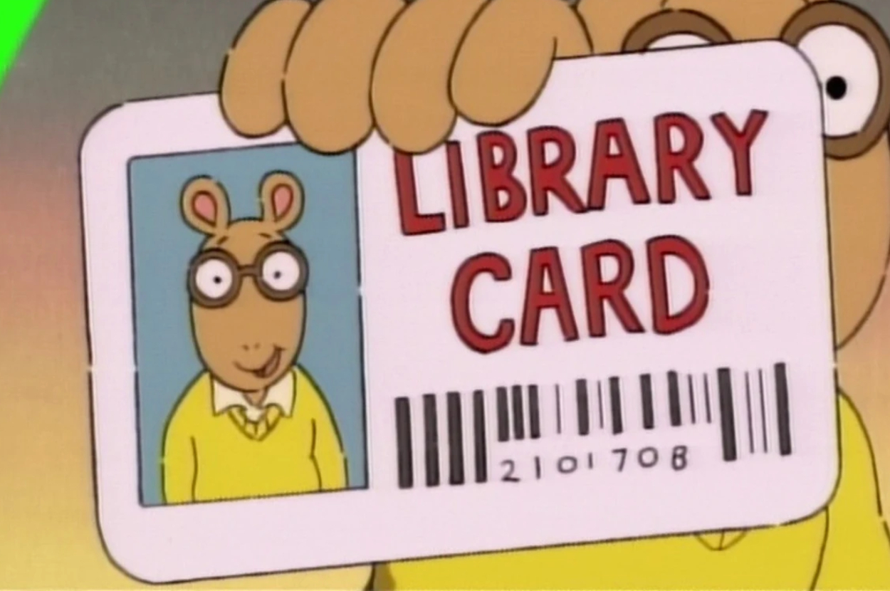 Arthur from &quot;Arthur&quot; holding up his library card