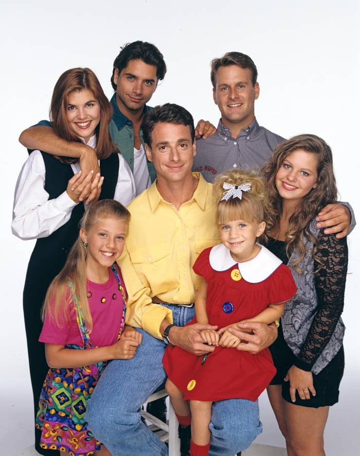 Group photo of the Full House cast: Lori Loughlin, John Stamos, Bob Saget, Dave Coulier, Candace Cameron Bure, Jodie Sweetin, and Mary-Kate/Ashley Olsen