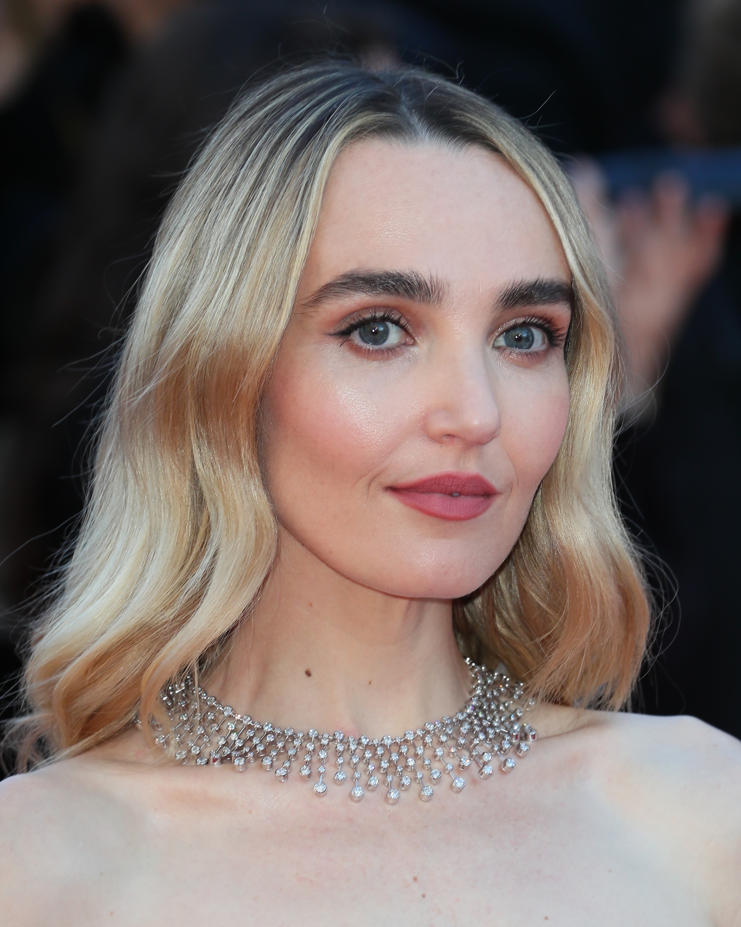 Chloe Fineman wearing a sparkling necklace with light wavy hair at a celebrity event