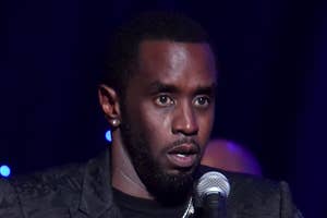Sean Diddy Combs speaks into a microphone at an event