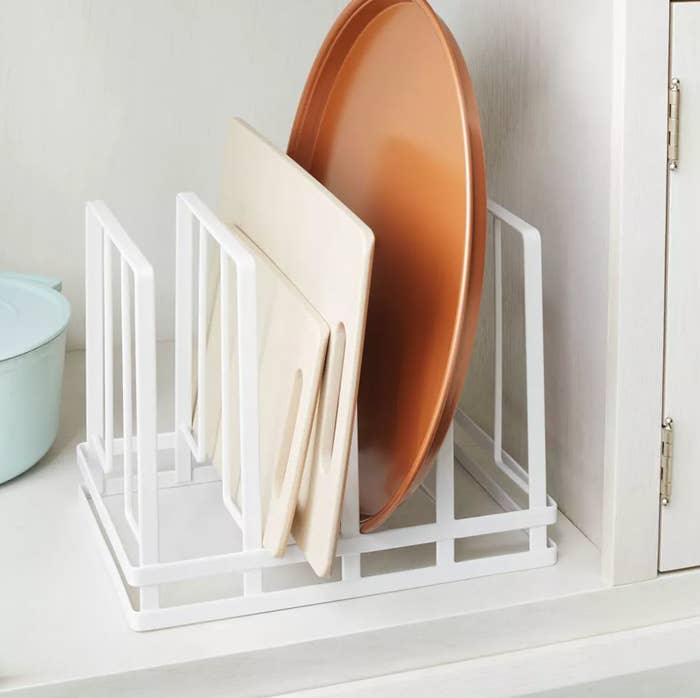 A dish rack with plates and a bowl neatly organized on a kitchen counter