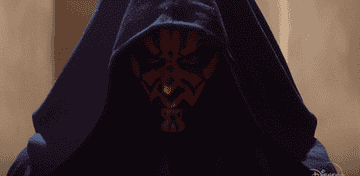 Darth Maul from Star Wars with face markings and hooded cloak, looking intense