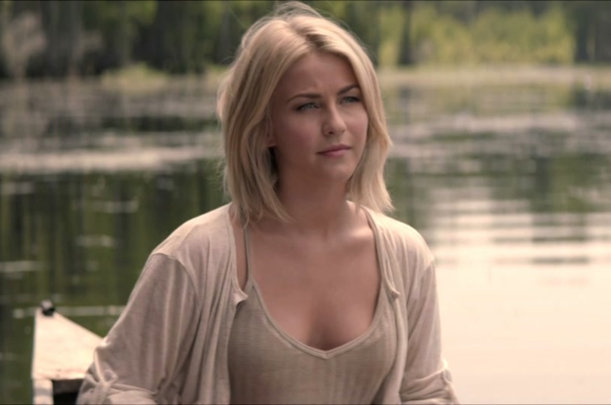 Woman in a casual shirt, standing outdoors, slight smile, looking to the side