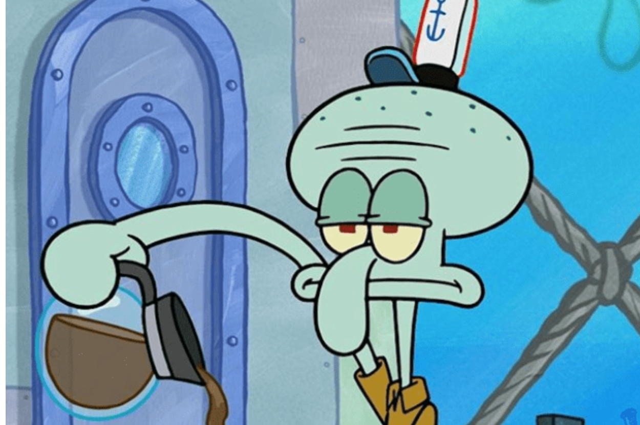 Squidward from SpongeBob SquarePants looks frustrated while holding a broom, standing indoors
