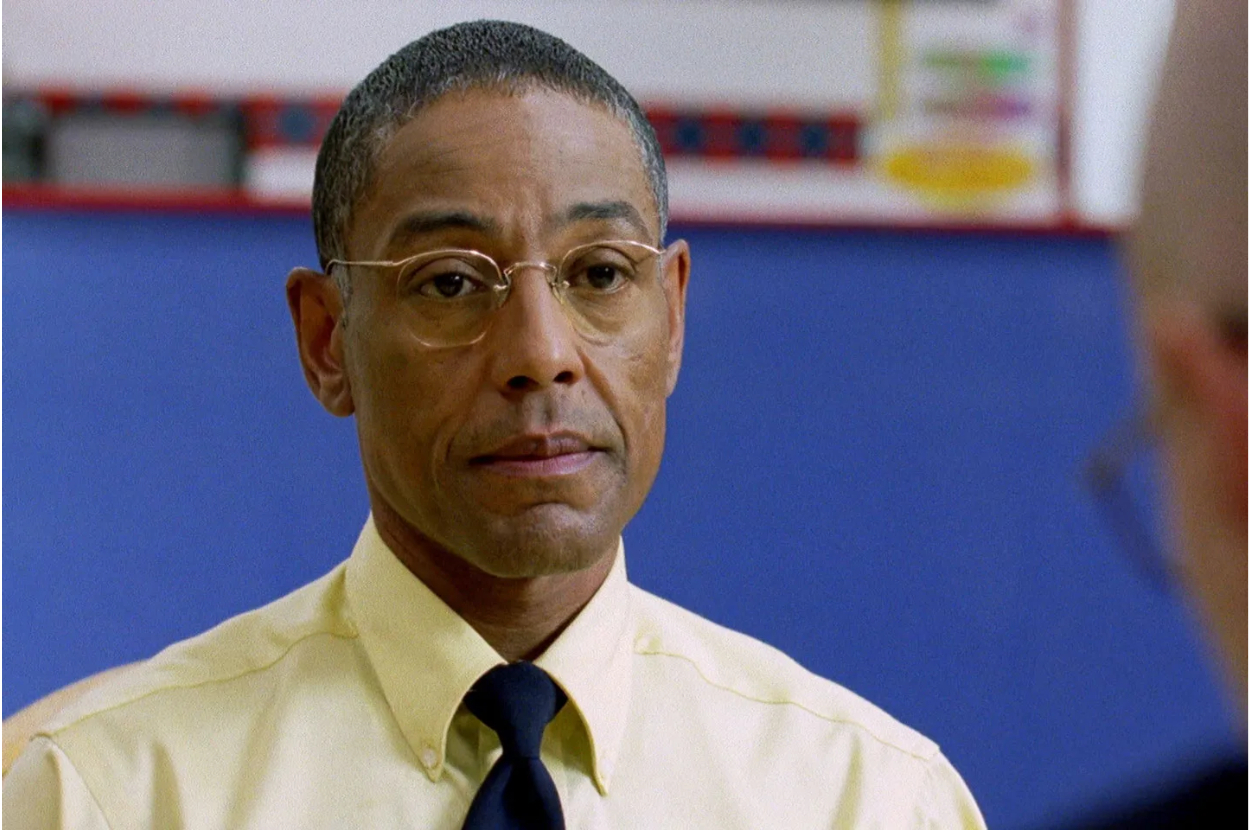 Gus Fring from Breaking Bad stands in a room with a concerned expression
