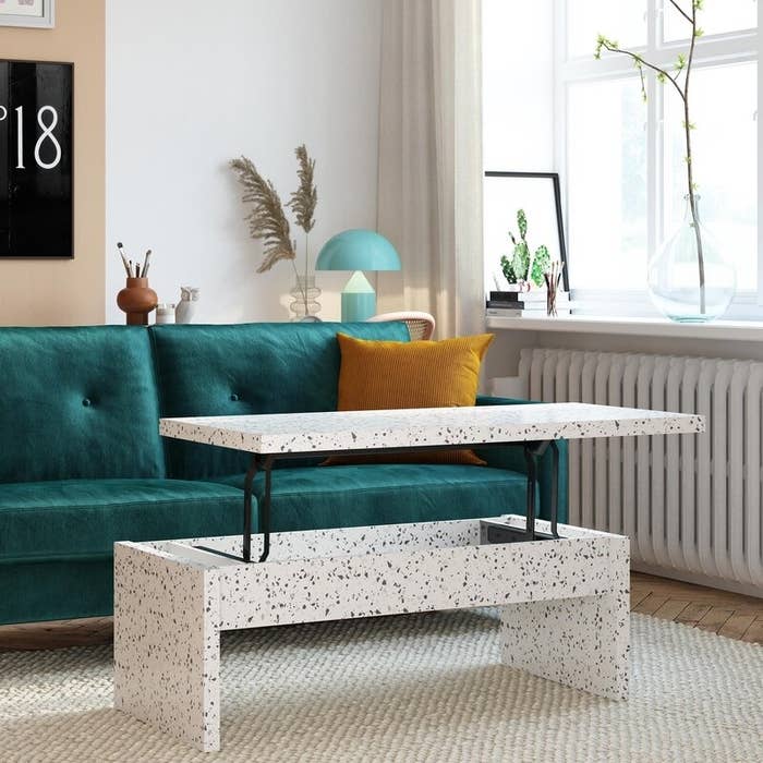 A terrazzo-style coffee table with matching side bench in a living room setting