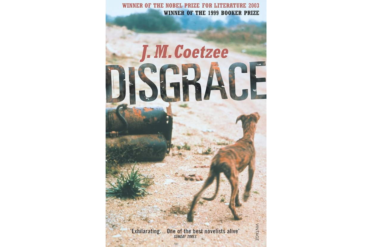 Book cover of &quot;Disgrace&quot; by J.M. Coetzee showing a dog walking away on a barren landscape