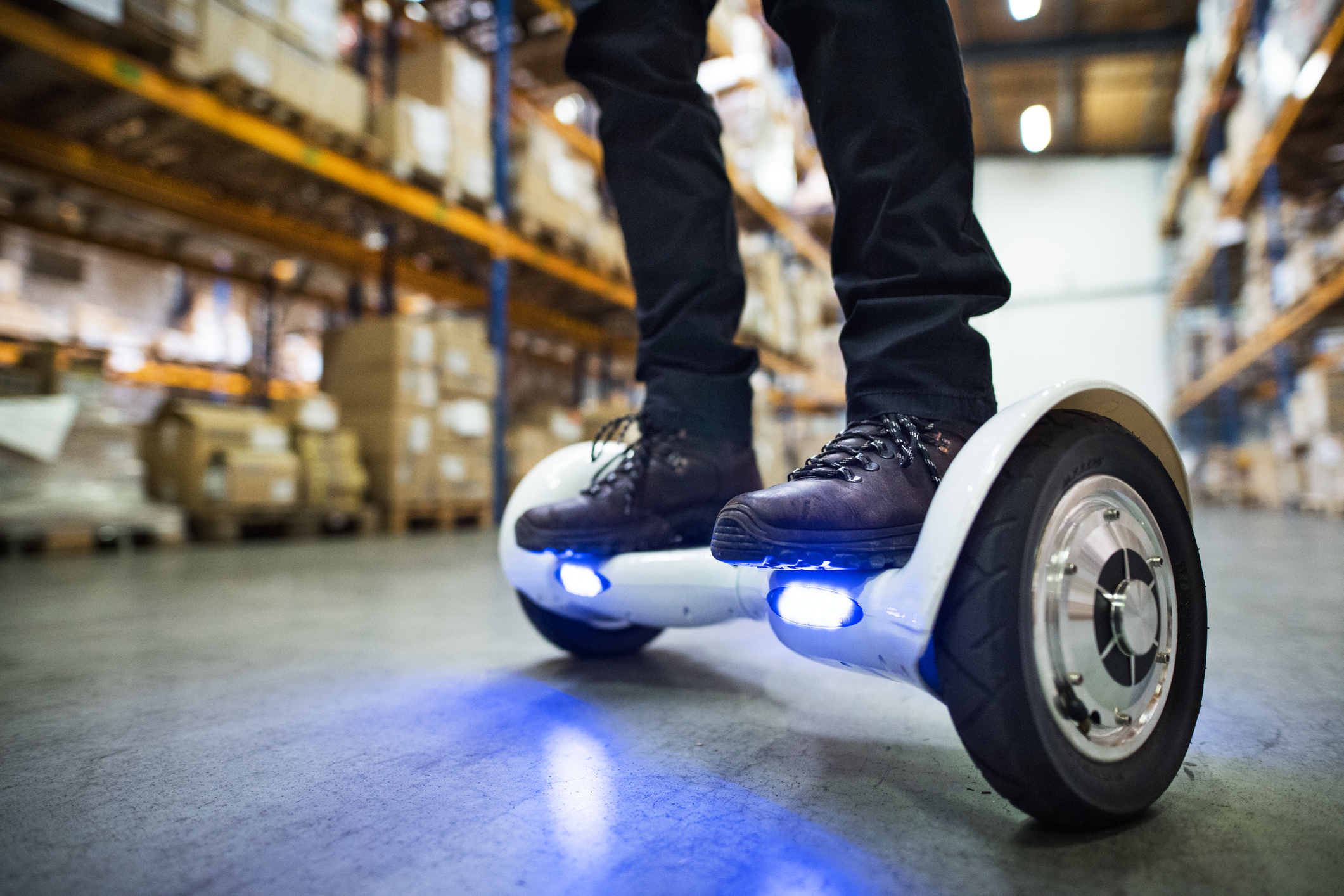Person riding a hoverboard in a warehouse