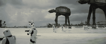 stormtroopers fire blasters on a beach