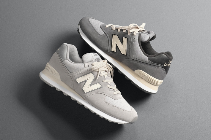 Two New Balance sneakers displayed on a plain surface, one slightly overlapped by the other