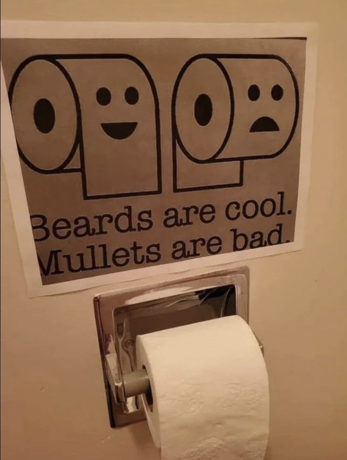 Sign reads &quot;Beards are cool. Mullets are bad.&quot; with happy/sad face icons, above a toilet paper holder