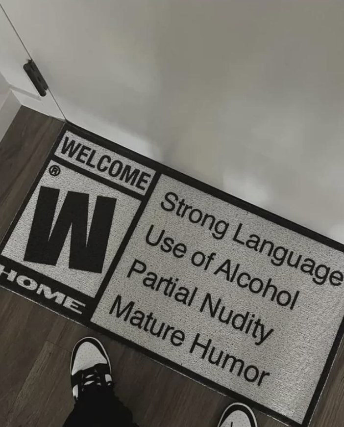 A doormat with content warning labels such as &quot;Strong Language&quot; and &quot;Mature Humor&quot;