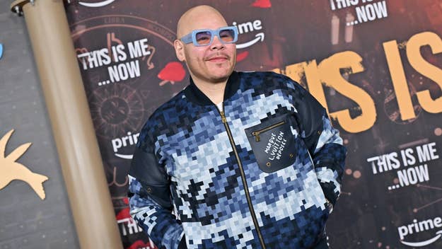 Man in a patterned jacket posing at a 'This Is Me Now' promotional event