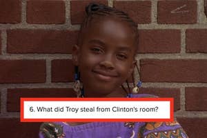 Young girl smiling in front of a brick wall with a TV show trivia question displayed at the bottom