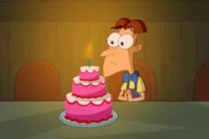 A young Doofenshmirtz from "Phineas and Ferb" sitting alone in front of a birthday cake.