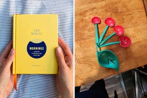 A person holds a yellow journal titled "Two Minute Mornings" next to measuring spoons shaped like cherries on a wooden surface