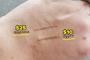reviewer with swatches of both the Nyx brow pencil and ABH brow pencil on their hand