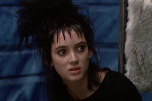 Lydia Deetz character from Beetlejuice film, with messy hair, looks surprised