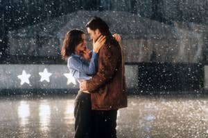 Two characters embracing in the rain at night, with star decorations in the background