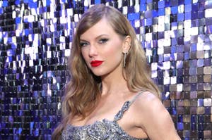 Taylor Swift wearing a sparkling sleeveless dress at an event with a shimmering backdrop