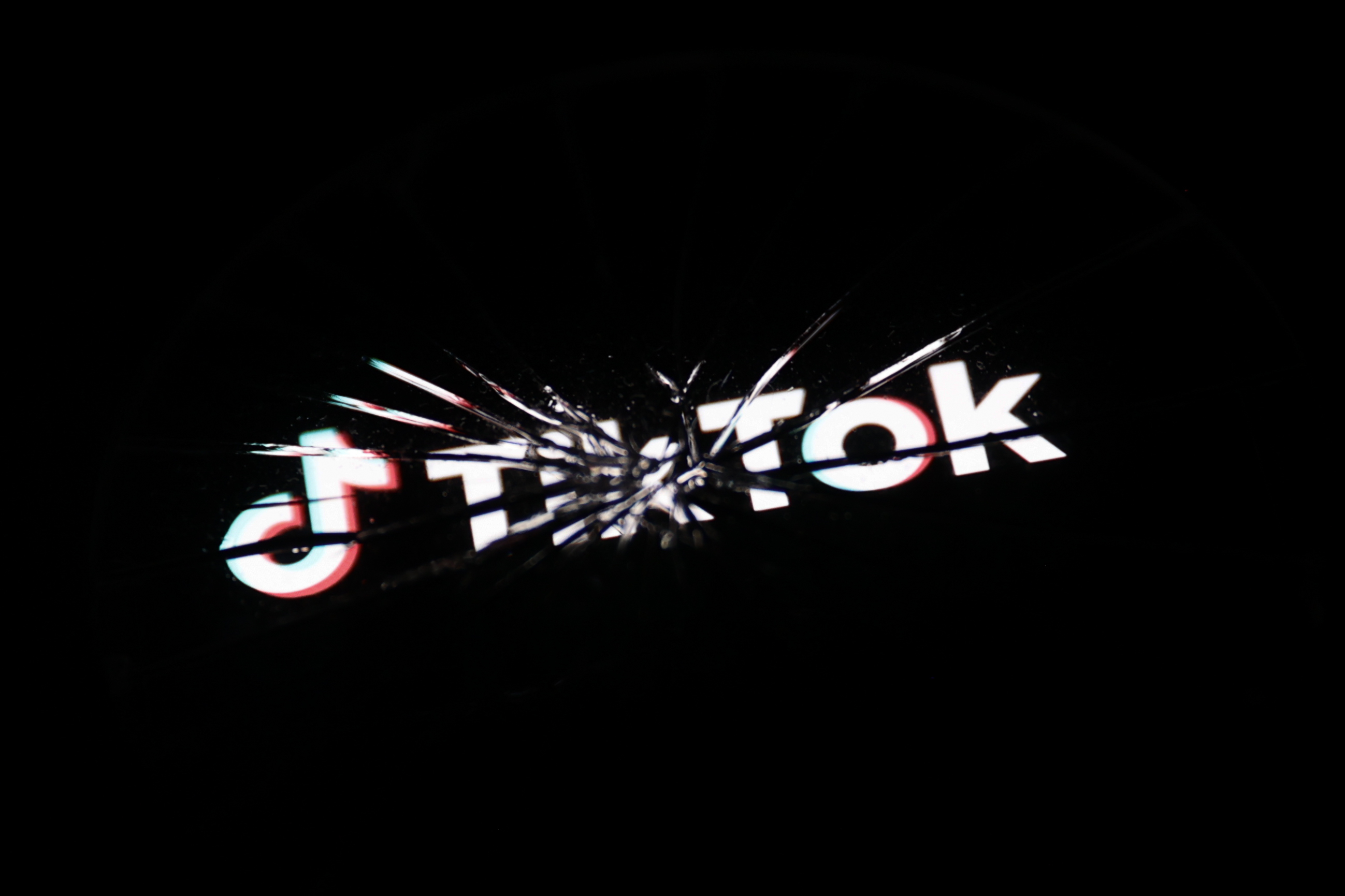 Cracked screen displaying the TikTok logo