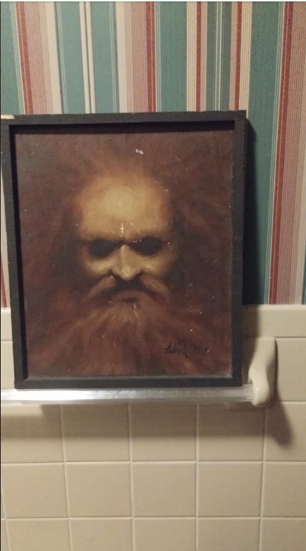 Painting of a bearded figure on a striped wallpaper background, displayed above a white towel rack