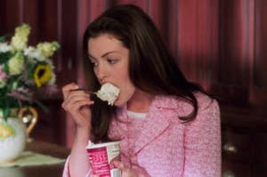 Anne Hathaway eating ice cream from the pint as Mia in The Princess Diaries 2
