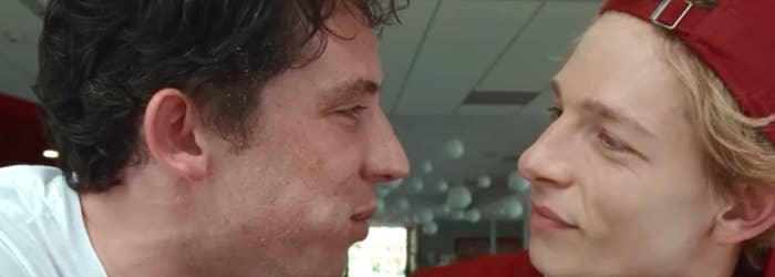 a scene from "Challengers"; Josh O'Connor faces Mike Faist as he eats a churro