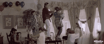 Robin Williams as Mrs. Doubtfire dances with children at a party scene in the movie