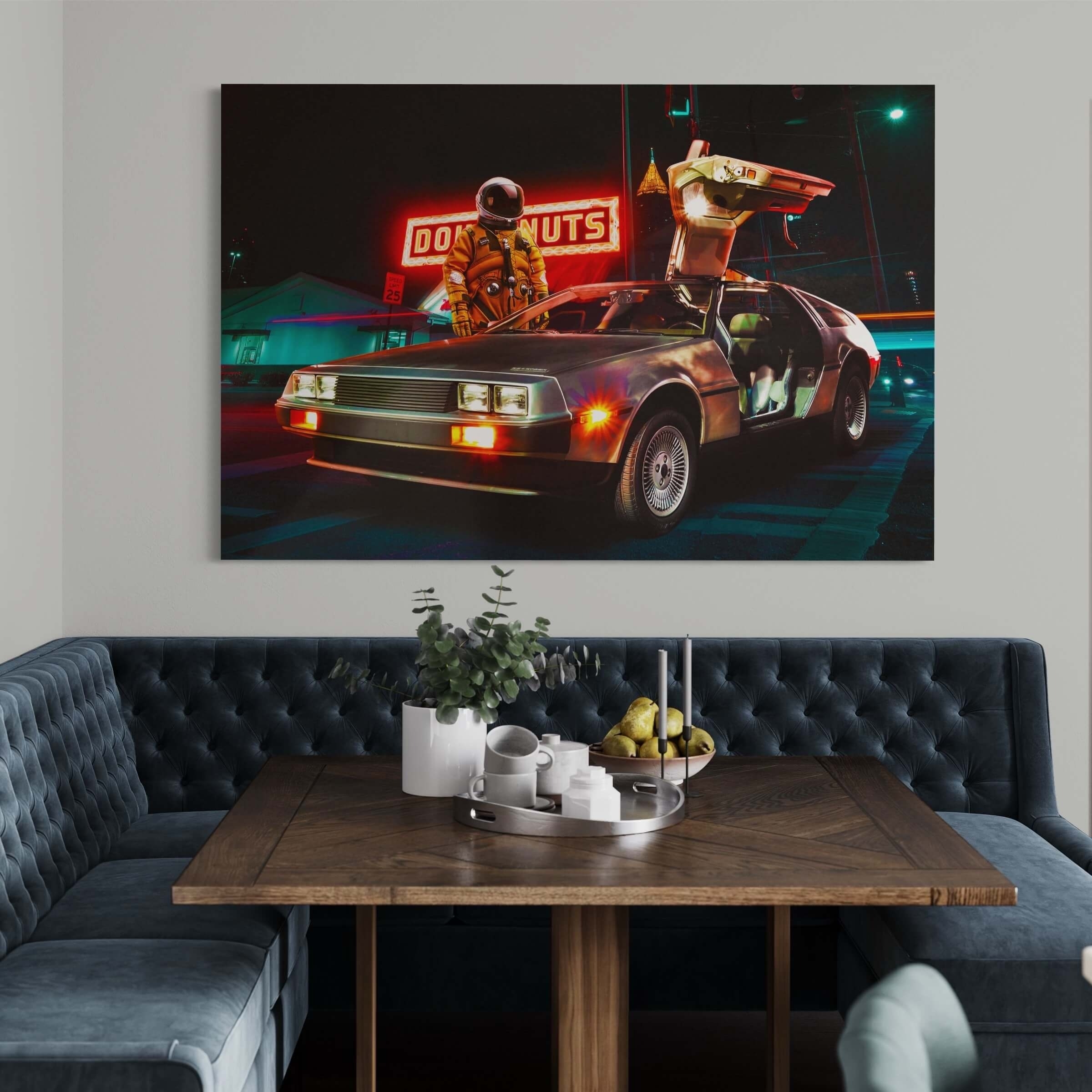 Wall art of a DeLorean car under neon lights with a figure holding a boombox, displayed above a couch