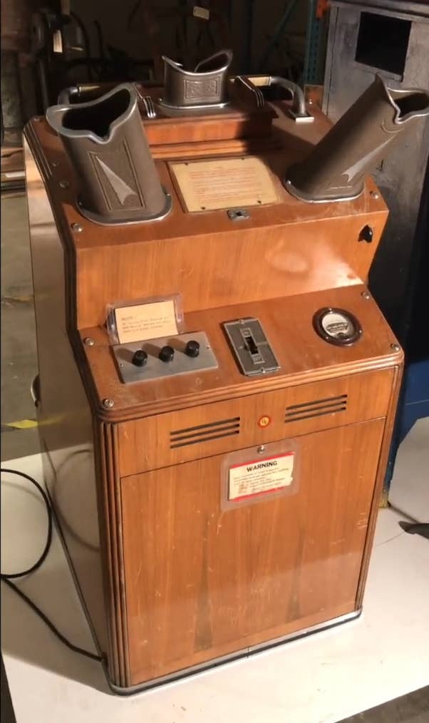 Vintage coin-operated viewing machine with dual binocular-like viewers