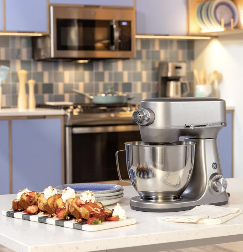 Modern kitchen with a stand mixer on the counter and a plated dessert in the foreground